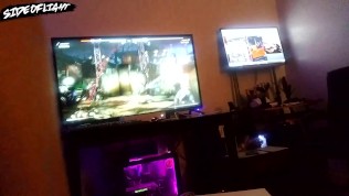 Fit white guy has sex with gamer girl sitting on lap while girl plays Mortal Kombat with male guest